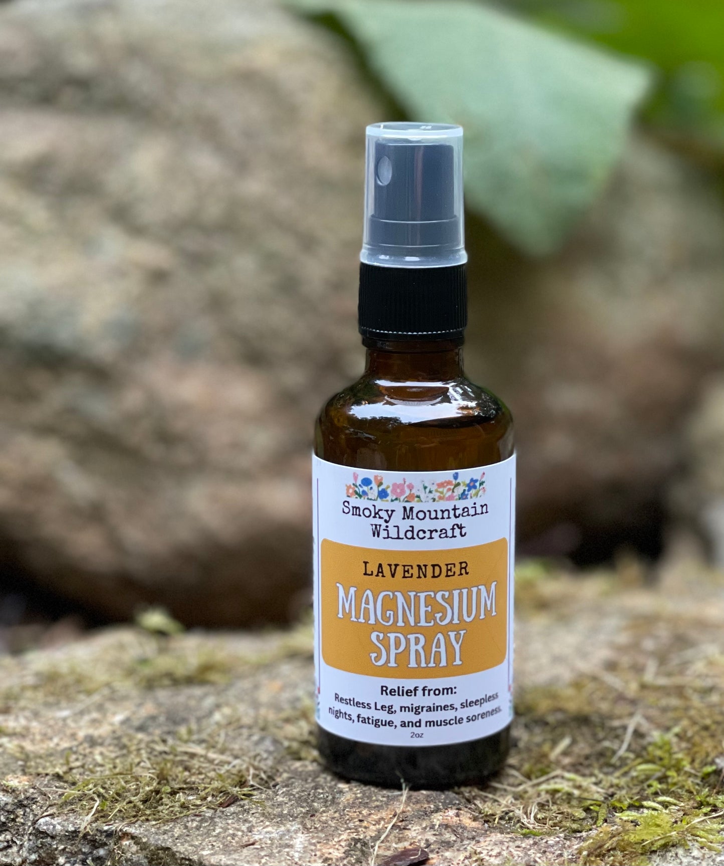 Bottle of Smoky Mountain Wildcraft Lavender Magnesium Spray on a natural stone background